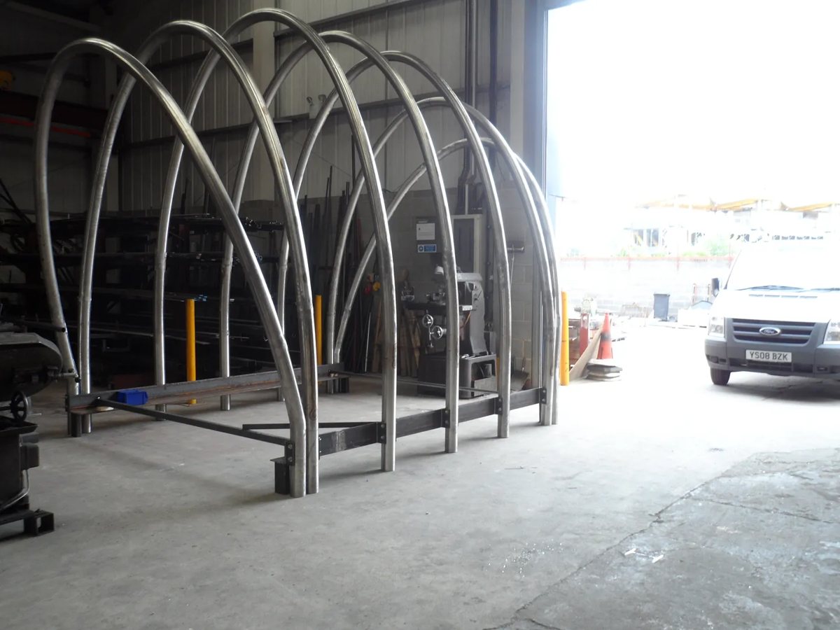 Stainless steel arch pergola trial built in mill finish on a temporary base frame in the fabrication workshop